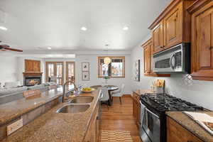 Kitchen featuring sink, a wealth of natural light, stainless steel appliances, and hanging light fixtures