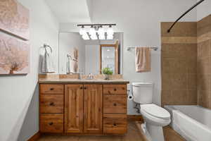 Full bathroom with tile patterned flooring, vanity, toilet, and tiled shower / bath