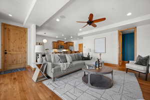 Living room featuring ceiling fan and light hardwood / wood-style flooring