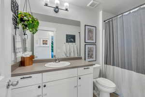 Bathroom featuring vanity, toilet, and a textured ceiling