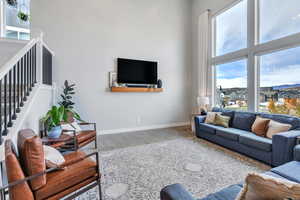 Living room with a high ceiling and carpet floors