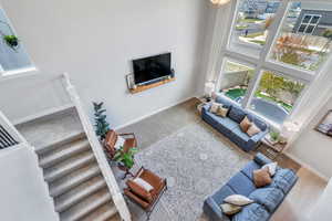 Living room featuring hardwood / wood-style floors and a high ceiling