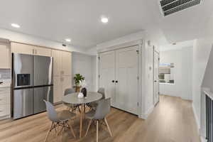 Dining room with light hardwood / wood-style flooring