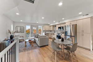 Living room with sink and light hardwood / wood-style floors