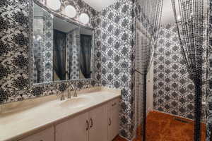 Bathroom featuring vanity, toilet, tub, shower