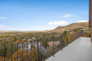 Balcony featuring valley and city views