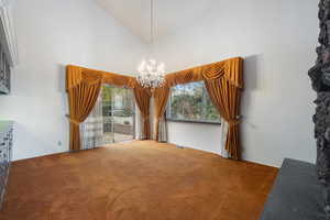 Interior space featuring a notable chandelier and high vaulted ceiling