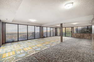 Basement featuring a textured ceiling and plenty of natural light