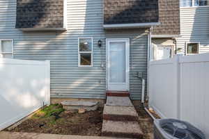 Enclosed Patio with Doorway to property with central AC unit