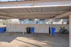 View of parking featuring a carport