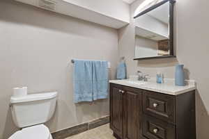 Master Bathroom featuring toilet, vanity, and tile patterned flooring- has large double head shower