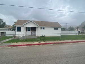 View of front of property featuring a porch and a front lawn