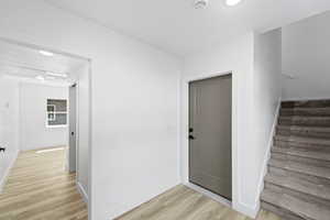 Interior space featuring a textured ceiling and wood-type flooring