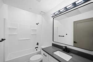 Full bathroom with vanity, toilet, and shower / bath combination