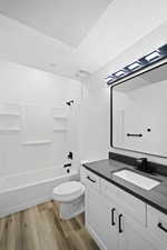 Full bathroom featuring bathing tub / shower combination, a textured ceiling, toilet, vanity, and hardwood / wood-style flooring