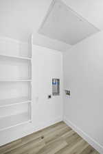 Laundry area featuring hookup for an electric dryer, hardwood / wood-style floors, and hookup for a washing machine