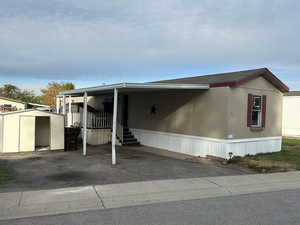 Manufactured / mobile home featuring a shed