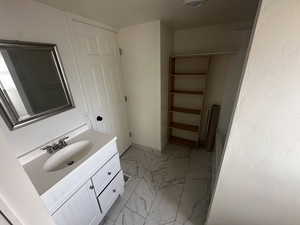 Bathroom with vanity and a textured ceiling