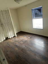 Unfurnished room with dark hardwood / wood-style flooring