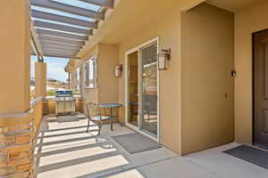 Balcony featuring a pergola and a patio