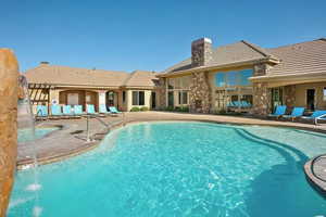 View of swimming pool with pool water feature and a patio