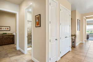 Corridor with light tile patterned floors