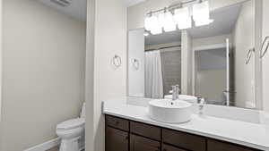 Bathroom featuring vanity and toilet