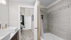 Bathroom with vanity and shower / bath combo