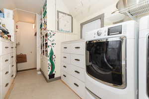 Laundry area with cabinets and washer and clothes dryer