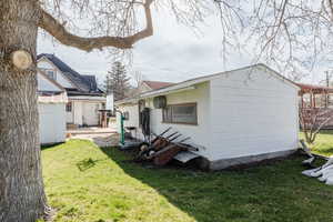 Rear view of property featuring a yard and a patio area