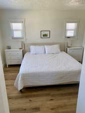 Bedroom featuring a textured ceiling and hardwood / wood-style floors