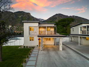 Exterior space with a lawn, a mountain view, and a balcony