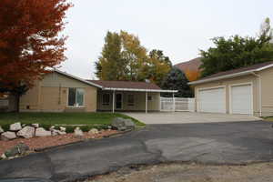 Single story home featuring a mountain view and a front yard