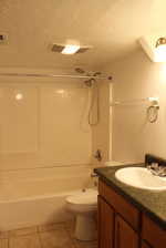 Full bathroom with shower / washtub combination, a textured ceiling, toilet, vanity, and tile patterned flooring