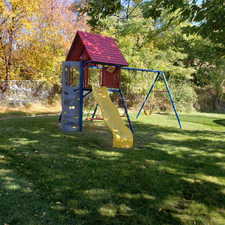 View of jungle gym featuring a lawn