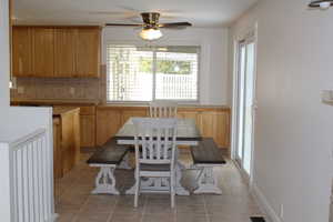 Tiled dining space with ceiling fan