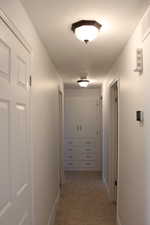 Hallway featuring light tile patterned flooring