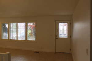 Foyer entrance with light tile patterned floors