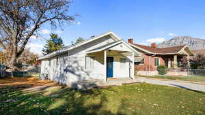 Bungalow-style house with a mountain view and a front lawn