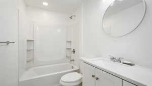 Full bathroom with vanity, shower / bath combination, and toilet