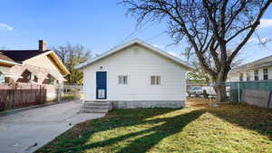 Back of house featuring a lawn