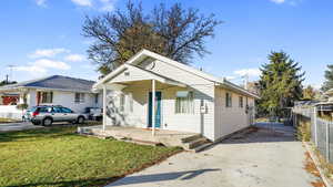 Bungalow-style home with covered porch and a front lawn