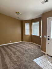 Carpeted spare room with a textured ceiling