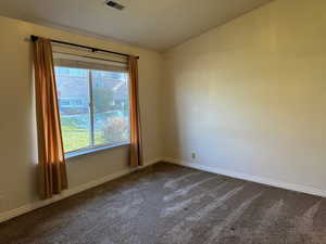 Unfurnished room featuring carpet floors and vaulted ceiling