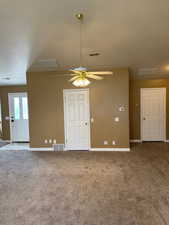 Unfurnished room with carpet flooring, a textured ceiling, and ceiling fan