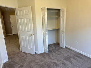 Unfurnished bedroom with carpet floors and a closet