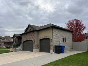 View of property exterior with a lawn and a garage