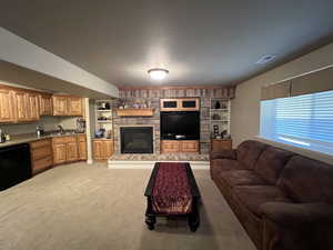 Carpeted living room with a fireplace, and built in entertainment center