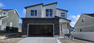 View of front facade featuring a garage