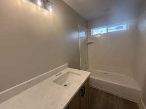 Bathroom featuring shower / tub combination and vanity